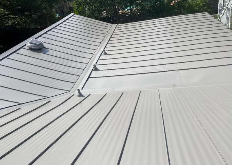 Solar attic fan installed on a metal roof for Roof Ventilation in Augusta